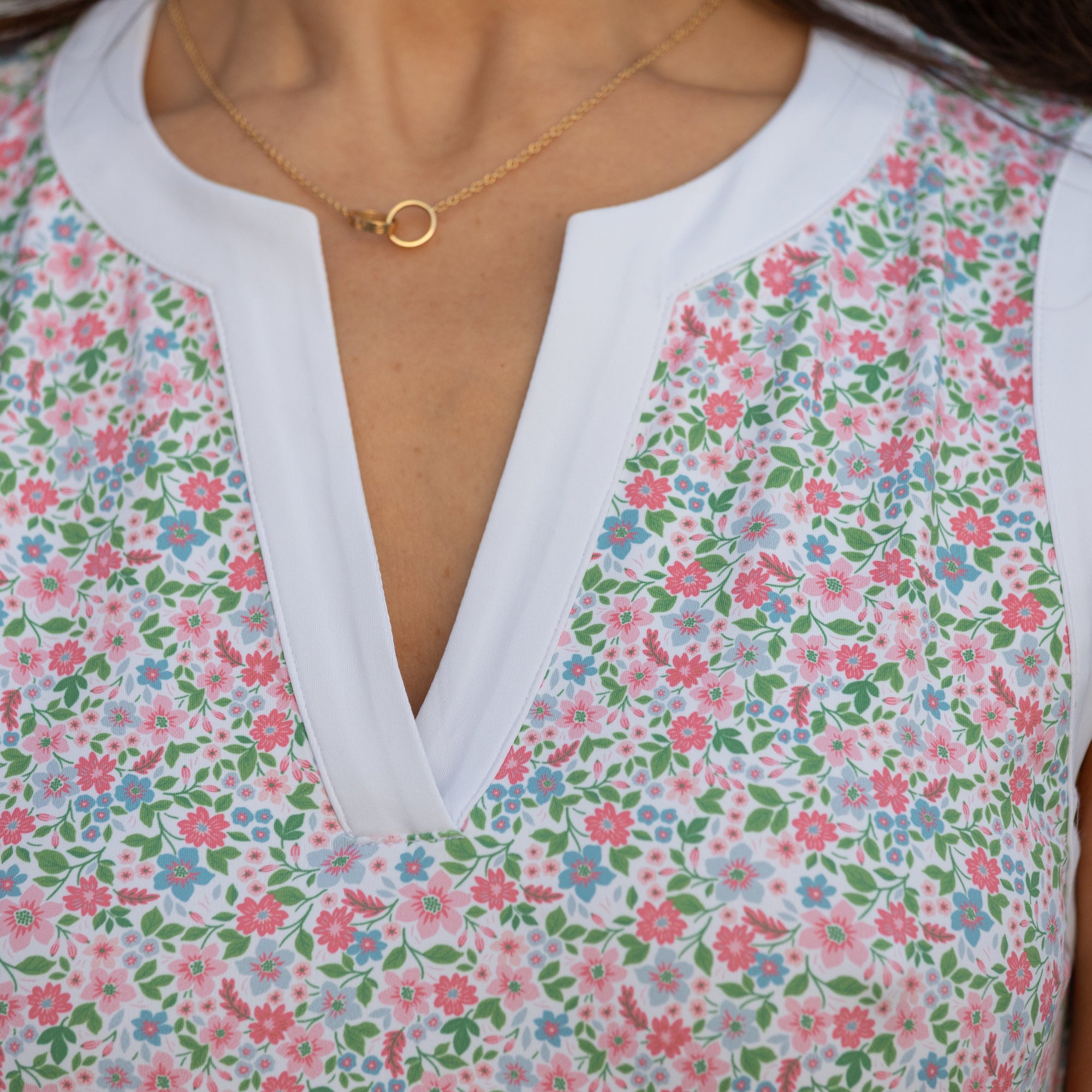 Floral dress with a white collar and gold necklace